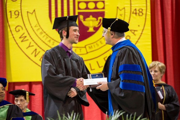 Kevin Bates '14 receiving his award at Honors Convocation from Gwynedd Mercy University Vice President for Academic Affairs Frank Scully, Jr., PhD.